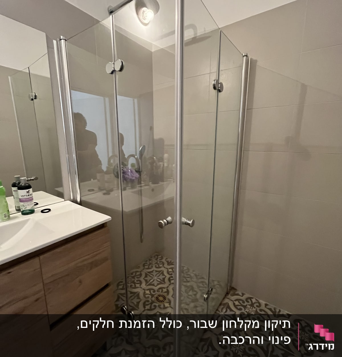 מקלחון זכוכית עם דלתות מתכת בחדר אמבטיה